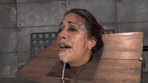 Sexy Brunette Lyla Storm Strictly Restrained In Stocks And Mercilessly Throat Trained... 2